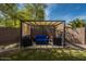 Shaded seating area with comfortable furniture for relaxing outdoors at 44566 W High Desert Trl, Maricopa, AZ 85139