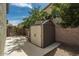 Backyard featuring a shed that provides ample storage space and organizational solutions at 44566 W High Desert Trl, Maricopa, AZ 85139