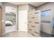 Bathroom featuring modern shower and view into adjacent bedroom at 44566 W High Desert Trl, Maricopa, AZ 85139