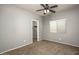 Neutral bedroom with carpeted floors, a closet and window at 44566 W High Desert Trl, Maricopa, AZ 85139
