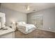 Cozy bedroom with neutral walls, ceiling fan, and bright natural light at 44566 W High Desert Trl, Maricopa, AZ 85139