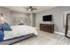 Lovely bedroom filled with light, fan, dresser, and large windows at 44566 W High Desert Trl, Maricopa, AZ 85139