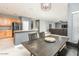 Open-concept dining room with hardwood floors, pendant lighting, and a stylish dining table at 44566 W High Desert Trl, Maricopa, AZ 85139