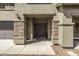 Front entrance with double doors, stone pillars, and a wide walkway leading to the home at 44566 W High Desert Trl, Maricopa, AZ 85139