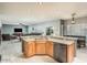 Modern kitchen with hardwood floors and open view to living and dining room at 44566 W High Desert Trl, Maricopa, AZ 85139