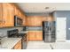 Well-lit kitchen featuring stainless steel appliances and light wood cabinetry at 44566 W High Desert Trl, Maricopa, AZ 85139