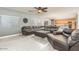 Bright living room featuring hardwood floors and comfortable leather seating at 44566 W High Desert Trl, Maricopa, AZ 85139