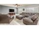 Spacious living room featuring hardwood floors and comfortable leather seating at 44566 W High Desert Trl, Maricopa, AZ 85139