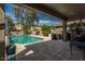 Relaxing covered outdoor pool area with nice patio and clear skies at 44566 W High Desert Trl, Maricopa, AZ 85139