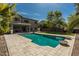 Large private pool with travertine deck and well-manicured yard at 44566 W High Desert Trl, Maricopa, AZ 85139