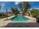 Inviting pool with cool, clear water is surrounded by lush landscaping at 44566 W High Desert Trl, Maricopa, AZ 85139