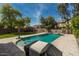 Private backyard pool is surrounded by desert landscaping and travertine tiling at 44566 W High Desert Trl, Maricopa, AZ 85139