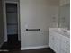 Bathroom featuring modern fixtures, vanity, and a walk-in closet at 4514 N 198Th Ln, Litchfield Park, AZ 85340