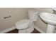 Bathroom with modern toilet and pedestal sink at 4514 N 198Th Ln, Litchfield Park, AZ 85340