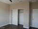 This bedroom has a closet with sliding doors and a standard door, plus laminate flooring at 4514 N 198Th Ln, Litchfield Park, AZ 85340