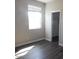 This bedroom features a window, wood-look flooring, and a walk-in closet at 4514 N 198Th Ln, Litchfield Park, AZ 85340