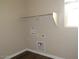 Laundry room features shelving and utility connections at 4514 N 198Th Ln, Litchfield Park, AZ 85340