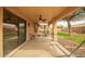 Spacious covered back patio perfect for relaxing, featuring a ceiling fan and access to a well-maintained backyard at 4909 W Pedro Ln, Laveen, AZ 85339