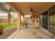 Spacious covered patio with ceiling fan and outdoor seating, ideal for enjoying the backyard at 4909 W Pedro Ln, Laveen, AZ 85339