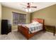 Cozy bedroom with warm green walls, a ceiling fan, and wood furniture, perfect for relaxation at 4909 W Pedro Ln, Laveen, AZ 85339