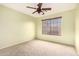 The bedroom features carpeted floors, a ceiling fan, and a window at 4909 W Pedro Ln, Laveen, AZ 85339