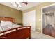 Bedroom featuring a bed, neutral carpet, and a closet, offering a simple and functional design at 4909 W Pedro Ln, Laveen, AZ 85339