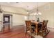 Dining area showcasing a solid wood table, chandelier, and an open layout that leads to other parts of the house at 4909 W Pedro Ln, Laveen, AZ 85339