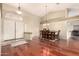 Open concept dining area with a wooden table, chandelier, and easy access to other living spaces and the front door at 4909 W Pedro Ln, Laveen, AZ 85339