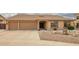 This inviting home showcases a three-car garage and low maintenance front yard with decorative rocks and mature landscaping at 4909 W Pedro Ln, Laveen, AZ 85339