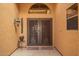 Up-close view of a decorative front entrance with a unique wrought iron double door, adding style and charm at 4909 W Pedro Ln, Laveen, AZ 85339