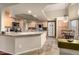 Well-lit kitchen has stainless steel appliances, an island, and ample cabinet space at 4909 W Pedro Ln, Laveen, AZ 85339