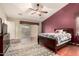 This main bedroom features hardwood floors, a ceiling fan, and a decorative rug at 4909 W Pedro Ln, Laveen, AZ 85339