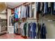This walk-in closet has wood shelves and clothing racks for ample storage at 4909 W Pedro Ln, Laveen, AZ 85339