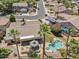 Aerial view showcasing a home with a pool, spa, covered patio, and desert landscaping in a suburban neighborhood at 5410 E Gable Ave, Mesa, AZ 85206