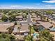 Wide aerial view of a neighborhood with palm trees, showcasing the property's pool and well-maintained desert landscaping at 5410 E Gable Ave, Mesa, AZ 85206