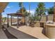 Outdoor seating with fire pit and cooking area next to pool at 5410 E Gable Ave, Mesa, AZ 85206