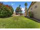 Lush green lawn with mature trees surrounding a beautiful, private backyard and pool area at 5410 E Gable Ave, Mesa, AZ 85206