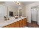 Bathroom with double sinks, wood cabinets, and wood-look flooring at 5410 E Gable Ave, Mesa, AZ 85206