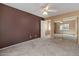 Spacious bedroom featuring mirrored closet doors, neutral carpet, and a ceiling fan at 5410 E Gable Ave, Mesa, AZ 85206