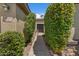 A welcoming front entrance is framed by verdant hedges leading to the front door of the residence at 5410 E Gable Ave, Mesa, AZ 85206