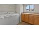 Laundry room with washer, dryer, and built-in cabinets at 5410 E Gable Ave, Mesa, AZ 85206