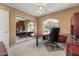 Well-lit office space featuring custom desk and cabinet built-ins, optimizing space and functionality at 5410 E Gable Ave, Mesa, AZ 85206