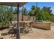 Outdoor kitchen with built-in grill, bar seating, and stylish pergola for outdoor dining at 5410 E Gable Ave, Mesa, AZ 85206