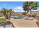 Backyard pool and spa with rock waterfall feature and mature palm trees at 5410 E Gable Ave, Mesa, AZ 85206