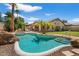 Backyard pool with rock features and gazebo, perfect for entertaining and outdoor relaxation at 5410 E Gable Ave, Mesa, AZ 85206