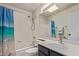 Bathroom with shower-tub combo, stylish vanity, and tile surround at 6734 S Brittany S Ln, Tempe, AZ 85283