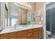 Bathroom featuring double sinks, wood cabinets, and updated lighting at 6734 S Brittany S Ln, Tempe, AZ 85283
