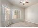 This bedroom boasts carpeted floors, a ceiling fan, and bright natural light at 6734 S Brittany S Ln, Tempe, AZ 85283