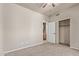Spacious bedroom with a ceiling fan, closet, and ensuite bathroom view at 6734 S Brittany S Ln, Tempe, AZ 85283