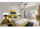 Cozy bedroom with a ceiling fan, sliding glass door to the backyard, and stylish decor at 6734 S Brittany S Ln, Tempe, AZ 85283